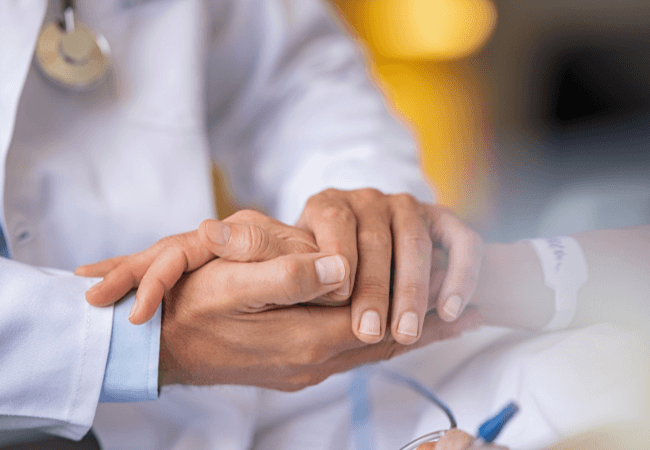 Doctor holding patient hands